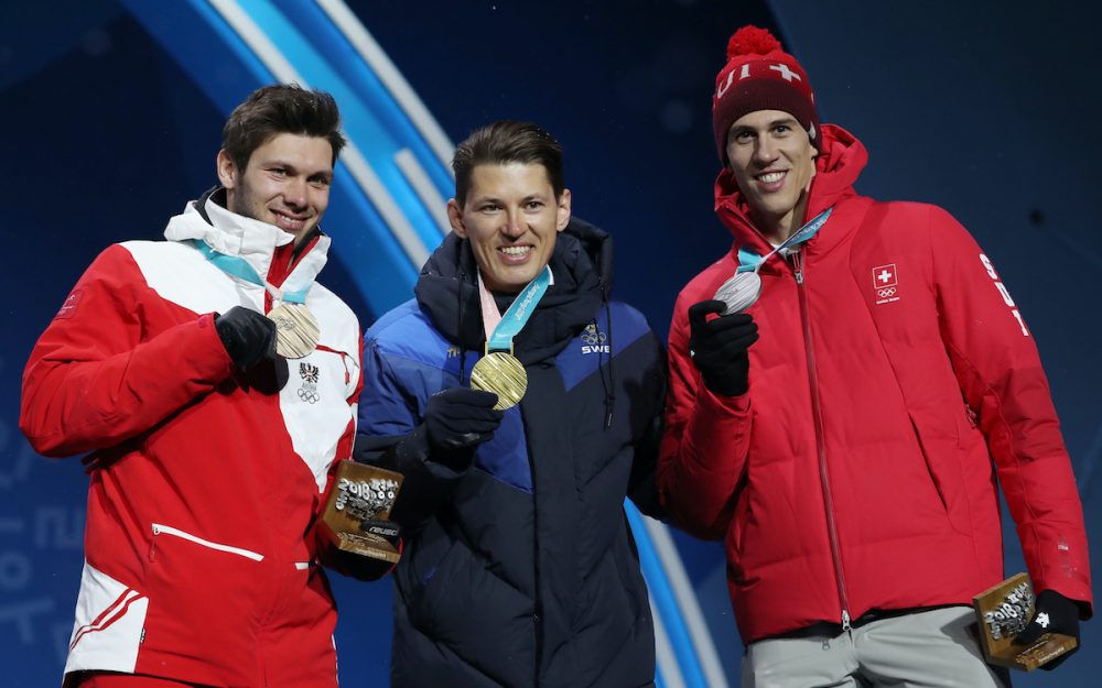 Michael Matt (links) und Ramon Zenhäusern (rechts) rahmen Olympiasieger Andre Myhrer ein. – Foto: GEPA pictures